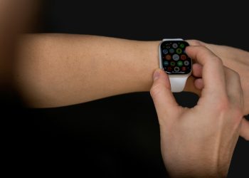 a person holding an apple watch in their hand