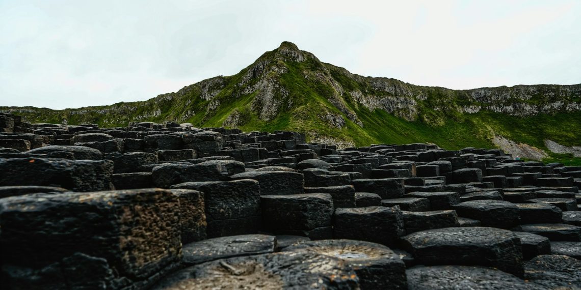 A large group of rocks with a mountain in the background