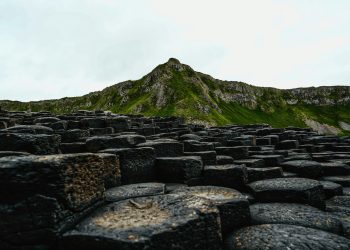 A large group of rocks with a mountain in the background