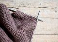 A pair of knitted gloves hanging on a clothesline