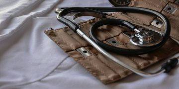 black stethoscope with brown leather case